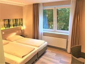 Postel nebo postele na pokoji v ubytování Hotel Scheid