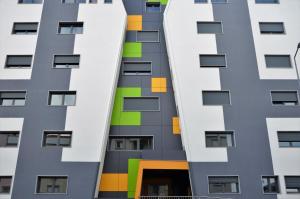 an external view of a building with colorful windows at Art'Estrela in Covilhã