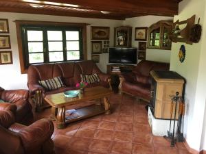 a living room with leather couches and a coffee table at CHATA Privlaky in Přívlaky