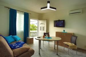 a living room with a couch and a table at Aparthotel Monterria in Bar