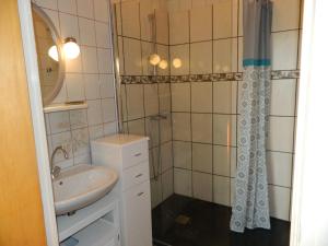 a bathroom with a sink and a shower at la berlie du jura in Étival +63 photos