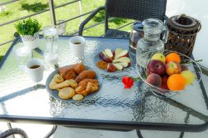 a glass table with two plates of food on it at Gatos Village Studios & Apartments in Asprovalta