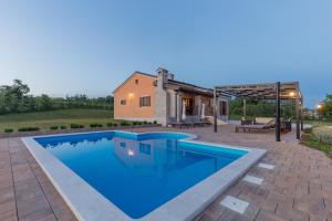 a swimming pool in front of a house at Villa Elida with Heated Pool - Central Istria in Pazin