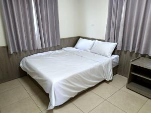 Postel nebo postele na pokoji v ubytování Yahweh Homestay