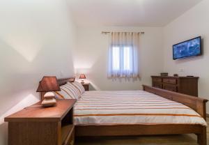 Un pat sau paturi într-o cameră la Vila Elida