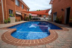 a swimming pool in the middle of a building at Meramie Motor Inn in Albury
