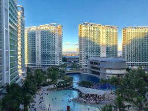 a view of a city with tall buildings and a pool at Azure Luxury Beach View Condo Staycation in Manila