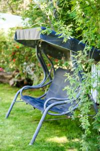a blue chair sitting in the grass at The Olive Garden in Limenas