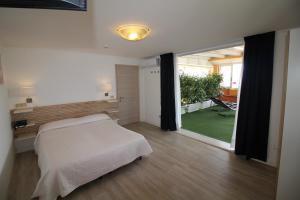 Postel nebo postele na pokoji v ubytování Hotel Rex