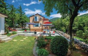 a home with a yard with a house at House Goga in Ledenice