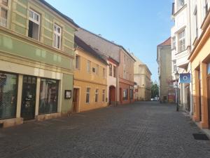 an empty street in a town with colorful buildings at Jüstel apartment in Litoměřice