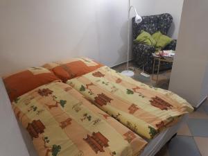 a bed with a blanket on top of it at Jüstel apartment in Litoměřice