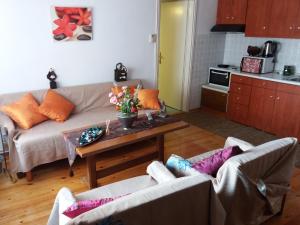 a living room with a couch and a coffee table at Traditional House Paschalis in Kavála