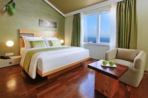 a bedroom with a bed and a chair and a window at Boutique Hotel Bol in Bol