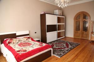 a bedroom with a bed and a closet and a door at Villa on Fetali Khan in Quba