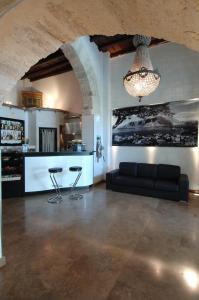 a living room with a couch and a chandelier at Ucciardhome Hotel in Palermo