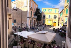a view of a courtyard with tables and umbrellas at A casa di Nicoletta in Tropea