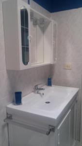 y baño con lavabo blanco y espejo. en Finestre Sul Mare Salento - Case Vacanze, en Punta Prosciutto