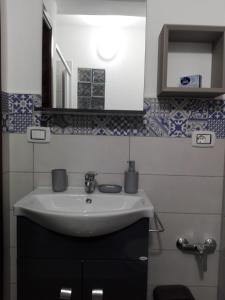 a bathroom with a sink and a mirror at Domus Mea in Trabia