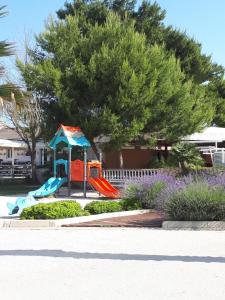 a playground with a slide in a park at Apartments Marija in Vir