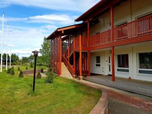a building with a porch and a balcony on it at Rauhan Marinella Village in Imatra
