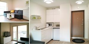 uma cozinha e uma sala de estar com armários brancos em 2 kambarių apartamentai em Palanga