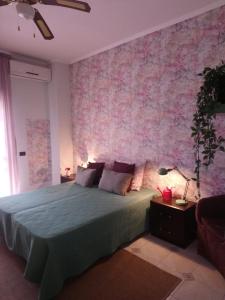 a bedroom with a large bed and a pink wall at Villa Axa in Casal Palocco