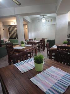 a dining room with wooden tables and chairs at Villa Axa in Casal Palocco