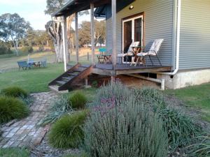 a porch of a house with a table and chairs at Woodenbong Bed and Breakfast in Woodenbong