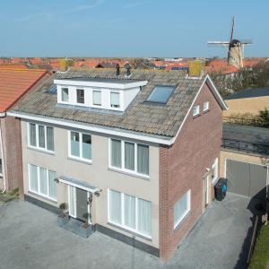 an aerial view of a house with a solar roof at B&B de Noorman in Westkapelle
