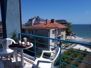 a balcony with a table and chairs and the ocean at Blue House - Синята къща in Obzor