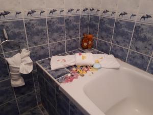 a bathroom with a bath tub with toys on it at Blue House - Синята къща in Obzor +48 photos