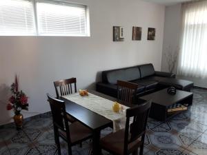 a living room with a table and a couch at Blue House - Синята къща in Obzor