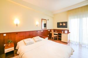 Postel nebo postele na pokoji v ubytování Hotel Merlot