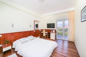 Postel nebo postele na pokoji v ubytování Hotel Merlot
