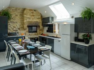 a kitchen with a table and chairs in a room at Holiday home with private pool in Plouguin