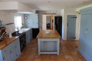 a kitchen with white cabinets and a counter top at The Cottage @ Mill Haven place in Pembroke