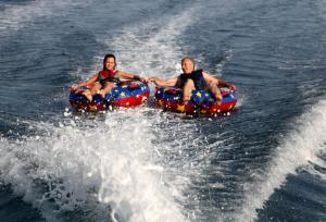 two people riding on two tubes in the water at Apartment Kiara in Omišalj