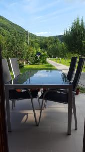 a table and two chairs sitting on a patio at Holiday Home Adna in Bihać