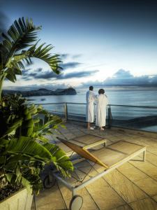 two people standing on a deck looking at the ocean at Senator Águilas in Águilas
