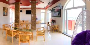 a dining room with a table and chairs at Golden Hotel in An Nhơn