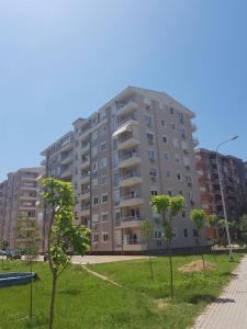 a large apartment building with trees in front of it at Bisera in Skopje