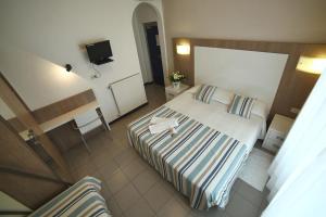 a hotel room with two beds and a television at Hotel Villa Rosa in Sestri Levante +47 photos