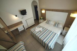 Säng eller sängar i ett rum på Hotel Villa Rosa
