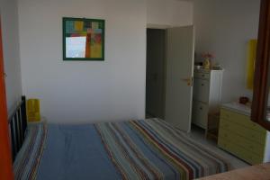 a bedroom with a bed and a dresser at Casa Del Mulino in San Vito lo Capo