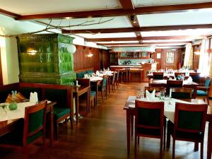 a restaurant with tables and chairs and a fireplace at Waldhotel Bad Sulzburg in Sulzburg