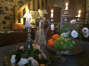 una mesa con platos de fruta y velas. en Domaine De La Bastille, en Saint-Malo