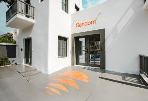 a white building with a santoni sign on it at Sandom in Parikia