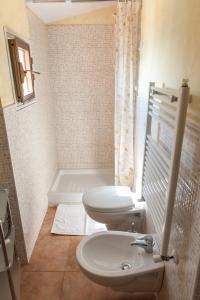 a bathroom with a toilet and a sink and a tub at Monolocale Marola in La Spezia