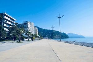 a empty street next to the ocean with buildings at Villa Georgiana in Gonio
